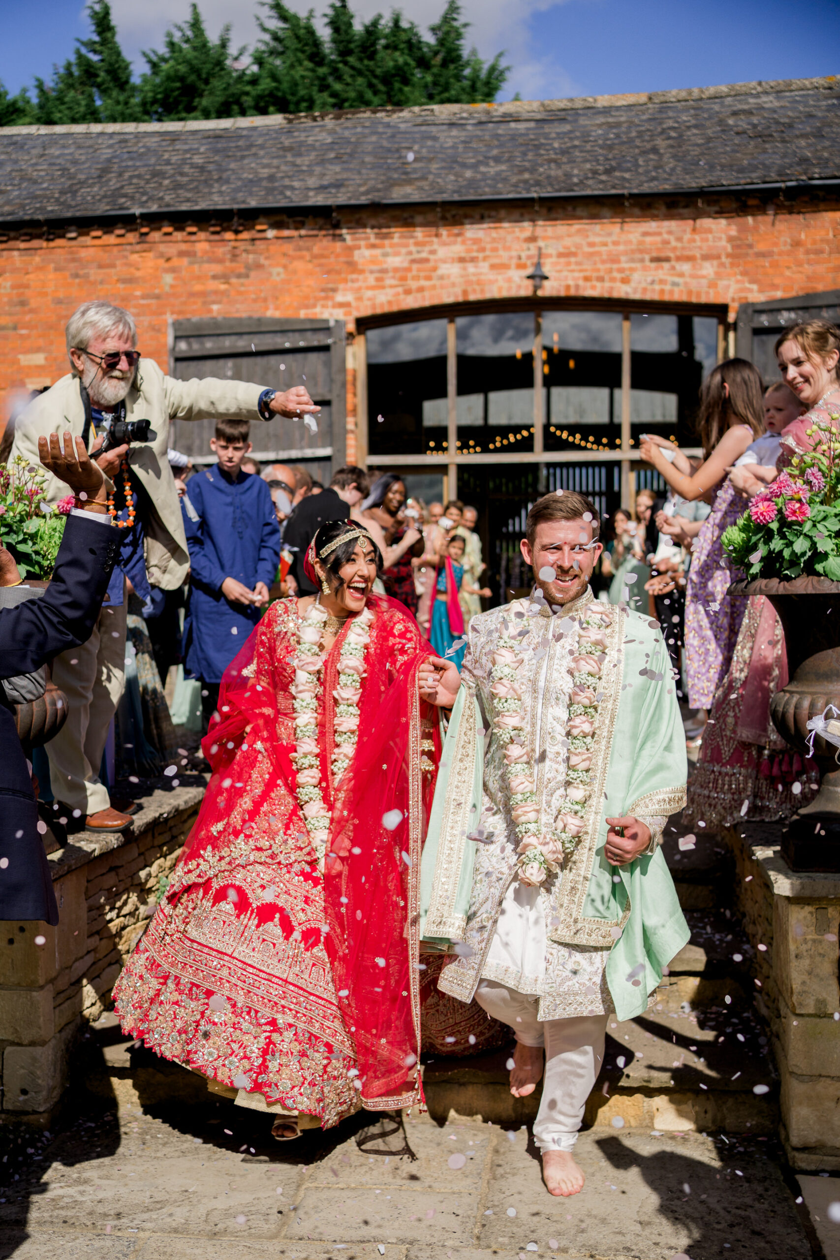 bride and groom are showered with confetti at mickleton hills farm wedding