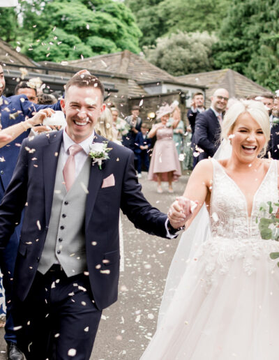 bride and groom showered with confetti. Photo by Lancashire Wedding Photographer Emma Billsborough