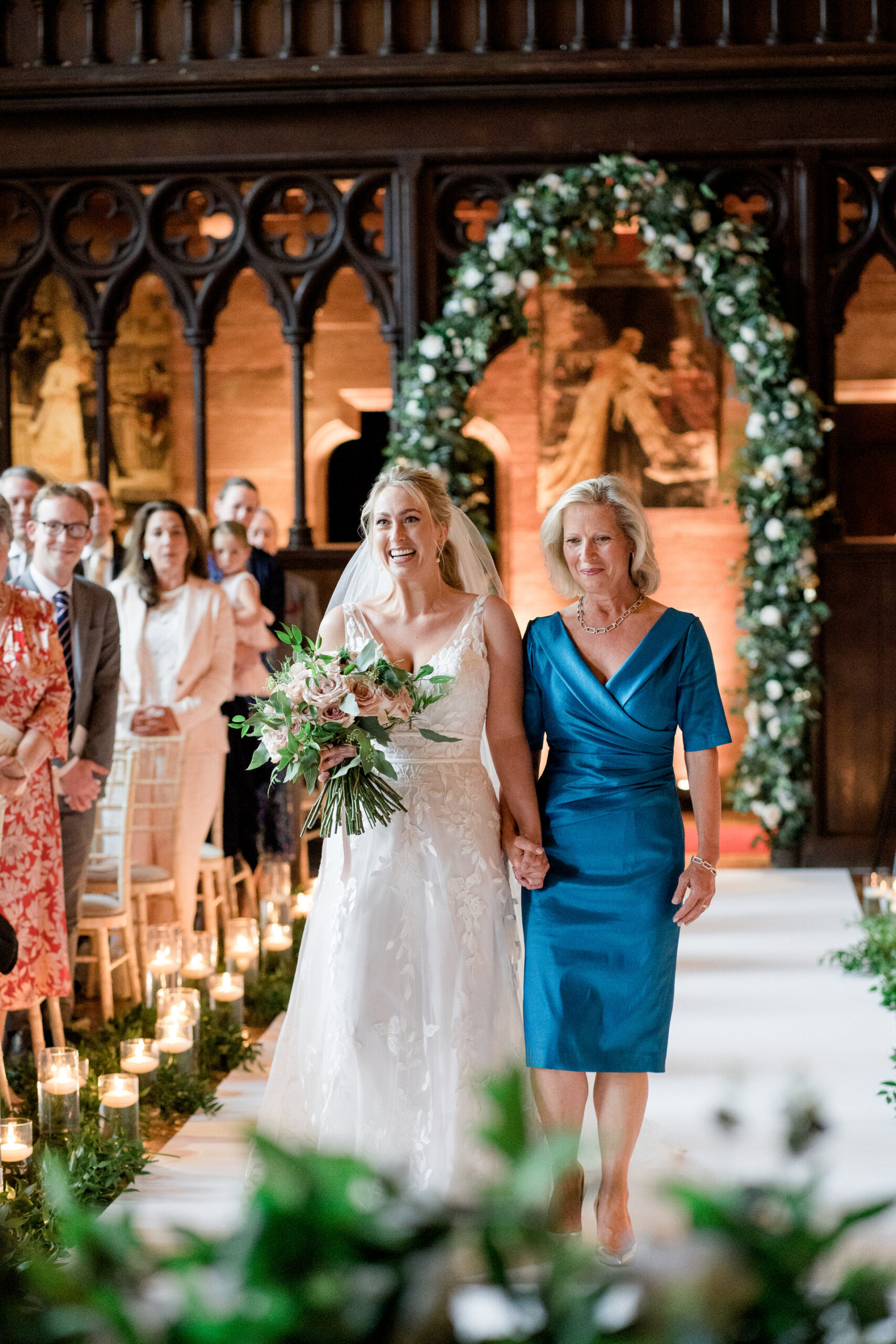 bride walks down the aisle with her mum at peckforton castle