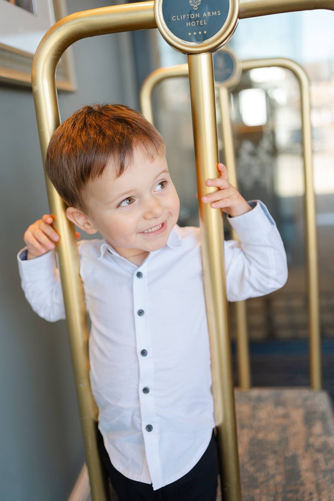 little boy climbs luggage carousel at Clifton arms hotel