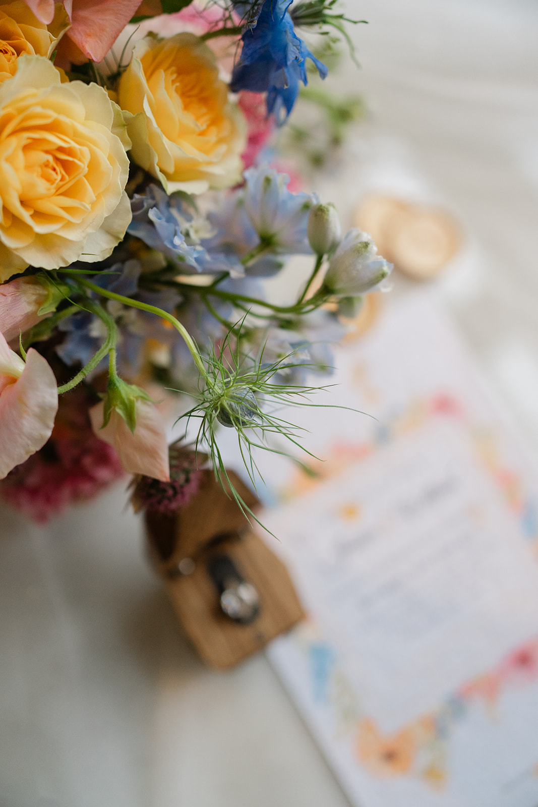 colourful wedding bouquet with yellow roses and hints of pale blue and pale pink