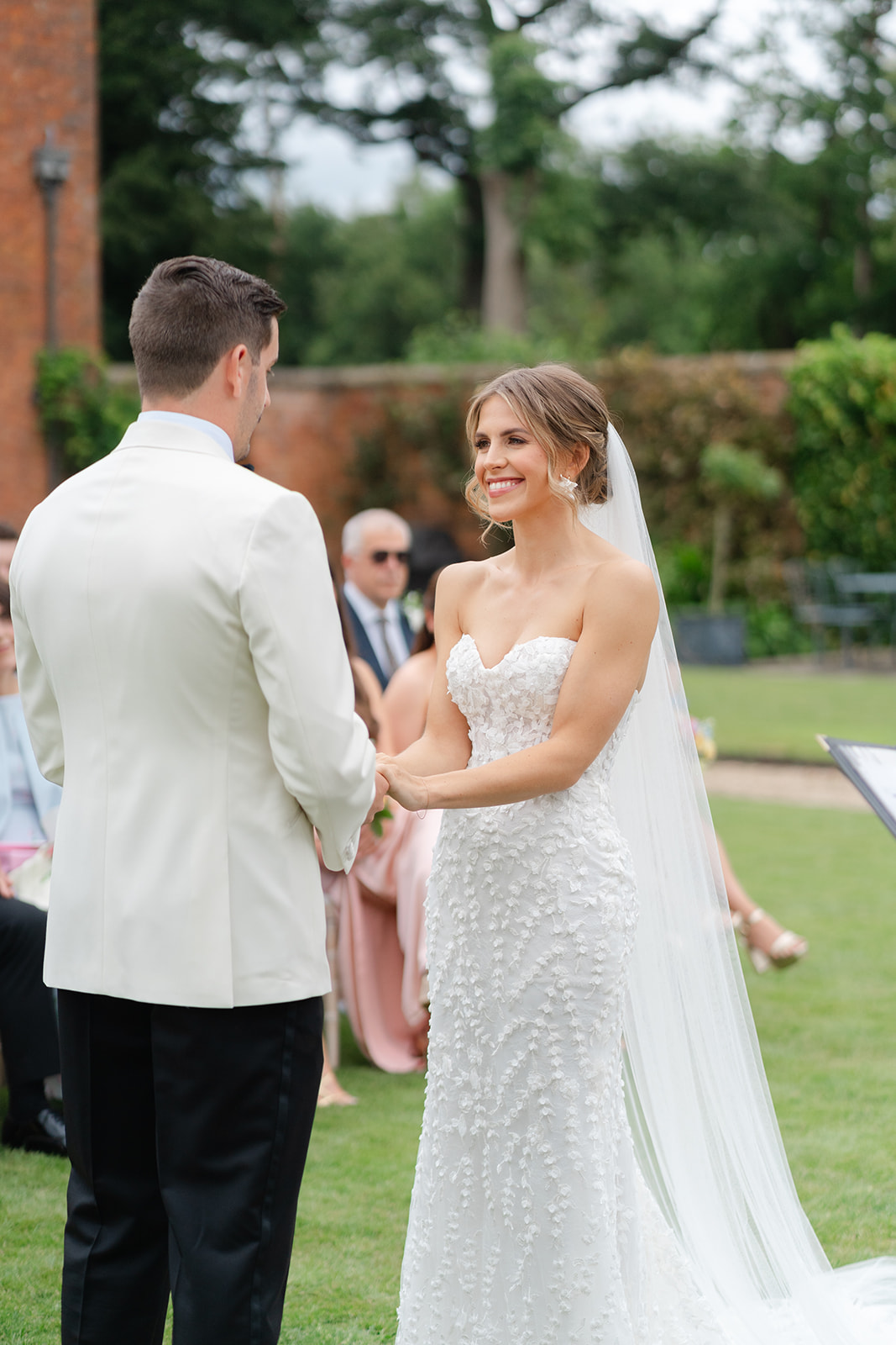bride and groom say their vows hand in hand