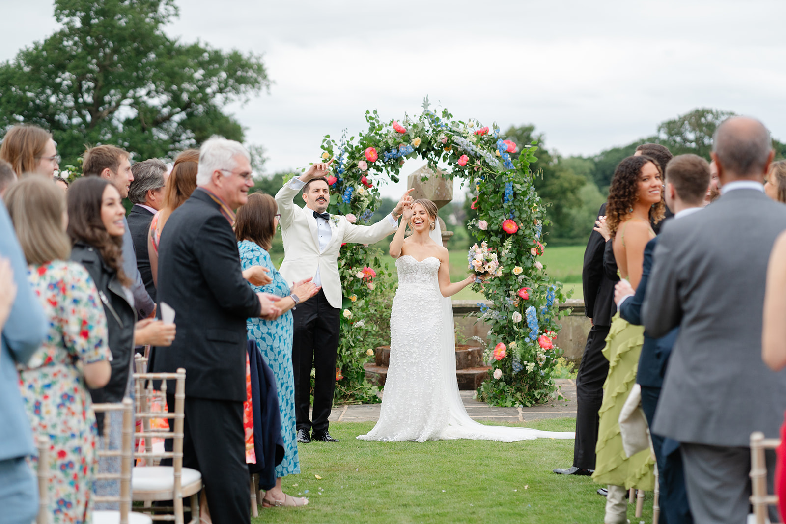 bride and groom celebrate at the top of the aisle