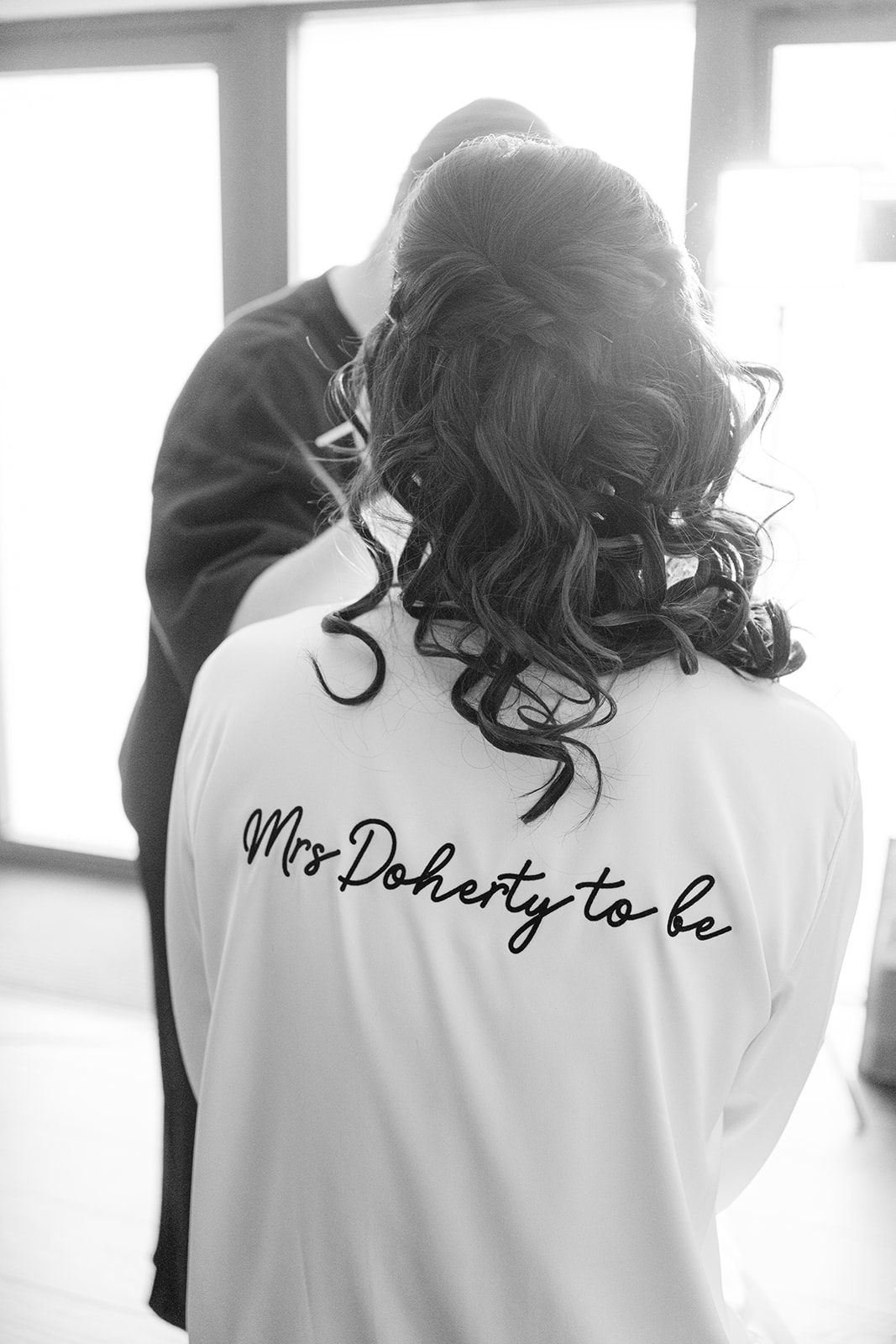 bride wearing robe the reads 'Mrs Doherty to be'