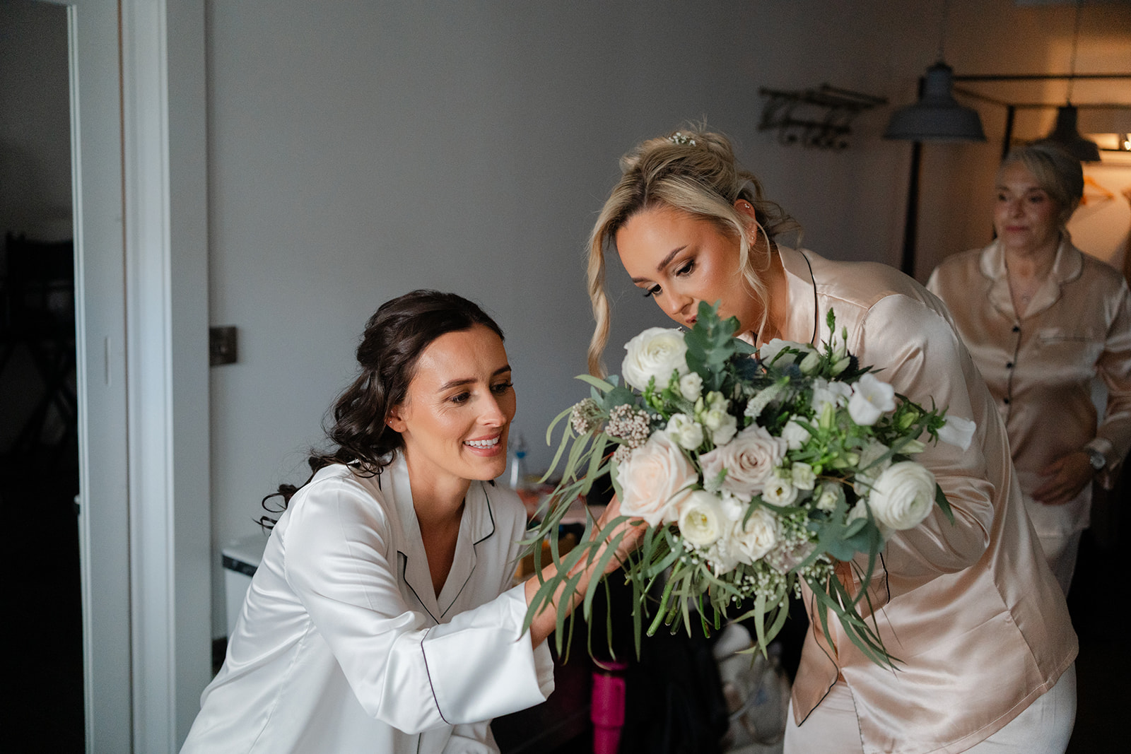 bridesmaid showing bride her bouquet
