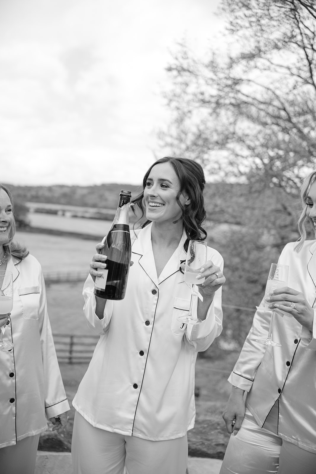 bride in pyjamas sips from champagne bottle