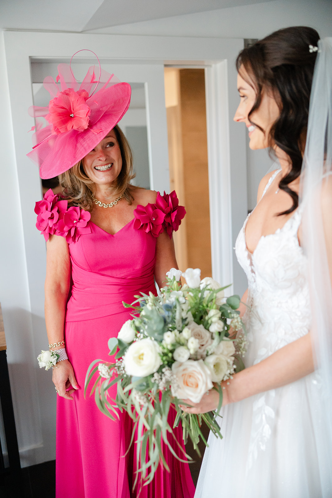 mother of the bride wearing Fuscia, sees her daughter for the first time on the morning of the wedding