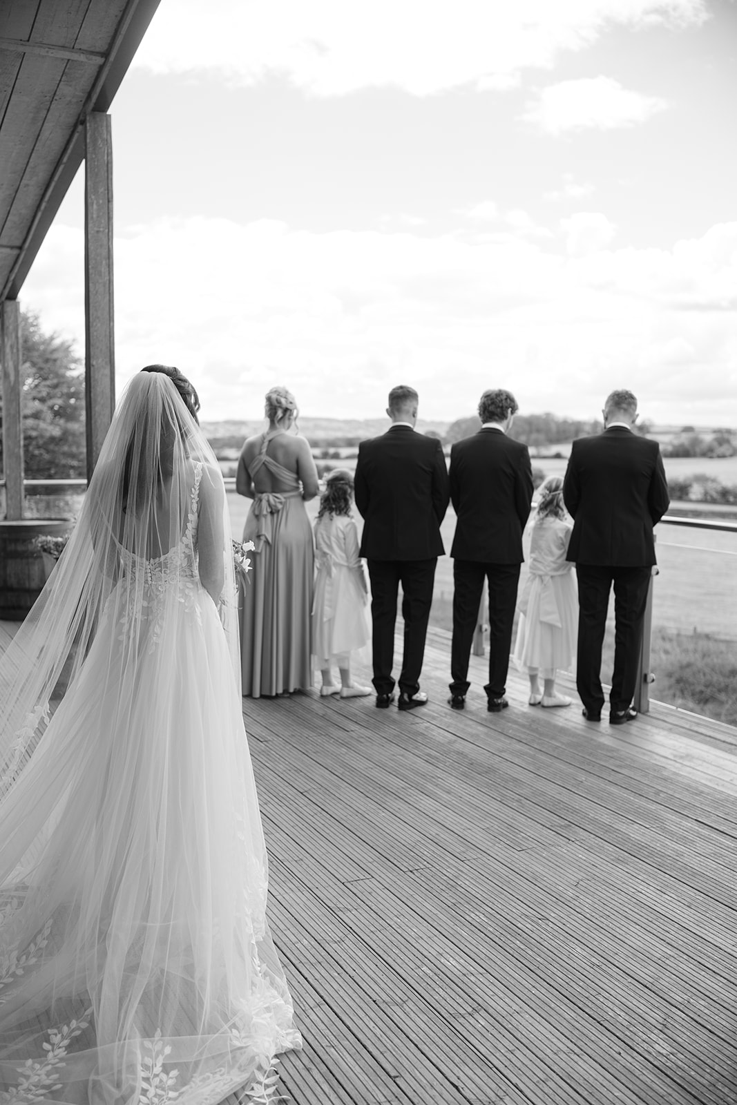 dress reveal with bridal party on the balcony at Bashall Barn