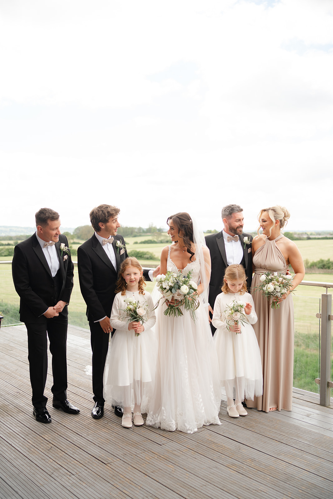 dress reveal with bridal party on the balcony at Bashall Barn