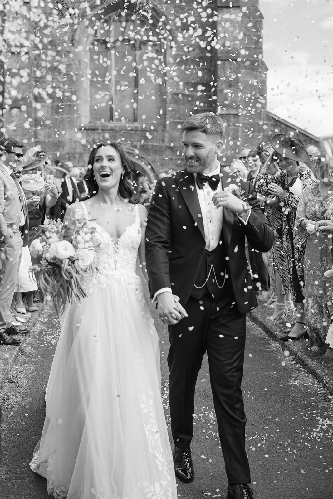 bride and groom are showered with confetti