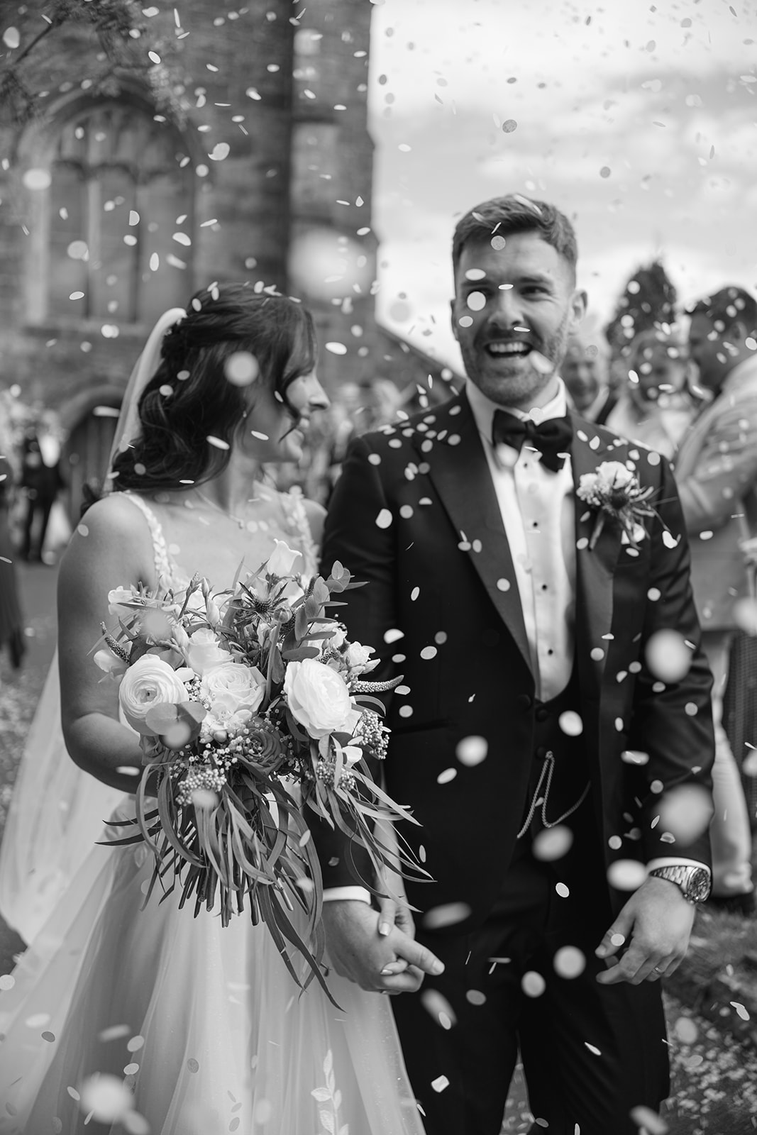 bride and groom under confetti throw