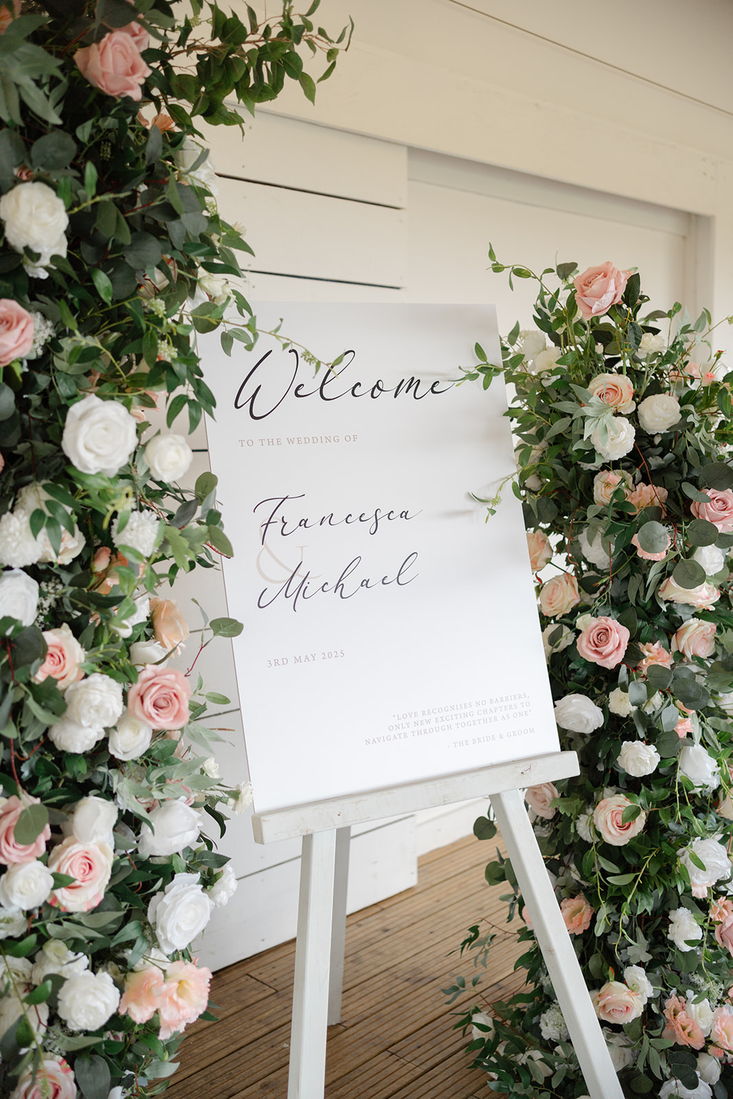 welcome sign with pink and green flowers at Bashall Barn