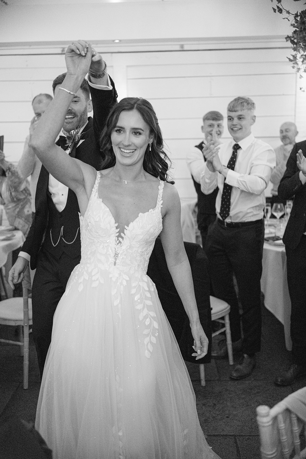 bride and groom enter wedding breakfast to cheers