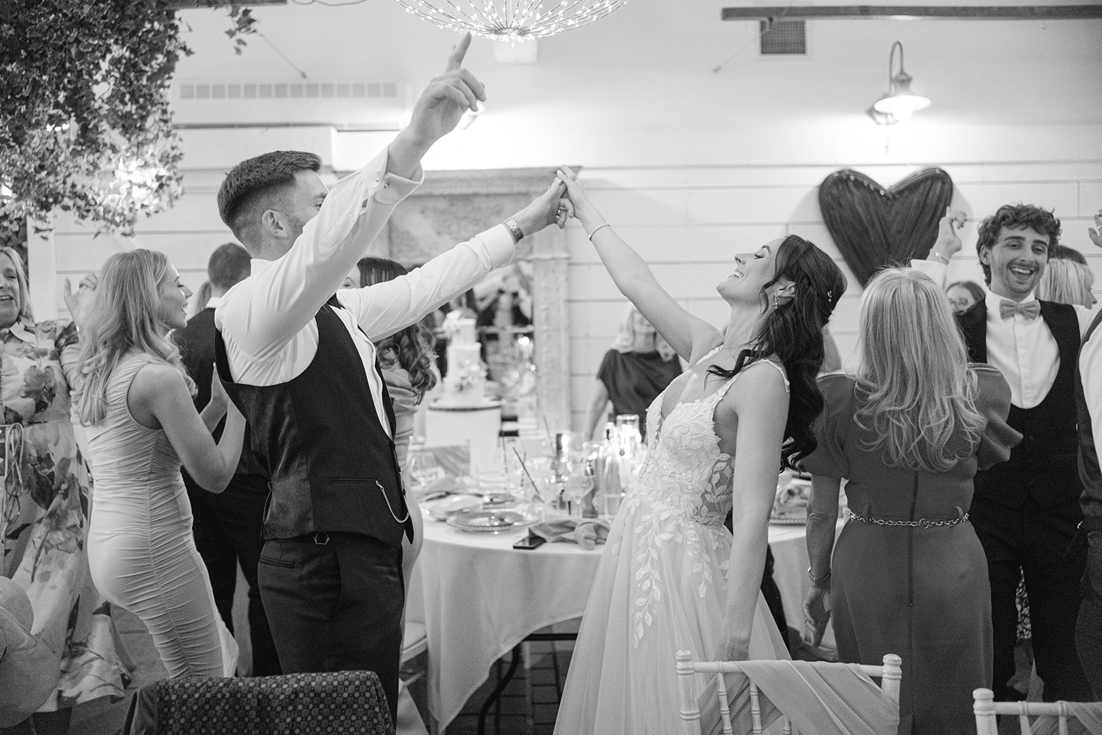 Bride and groom sing and dance during wedding breakfast at Bashall Barn