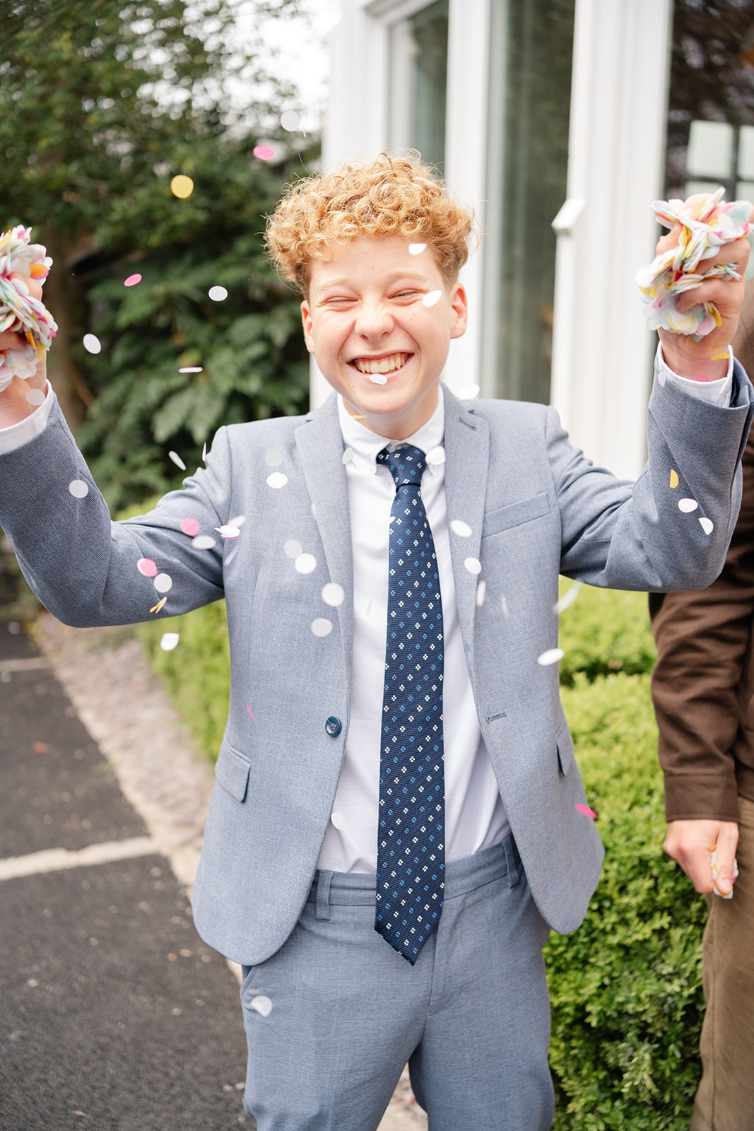 boy throws confetti