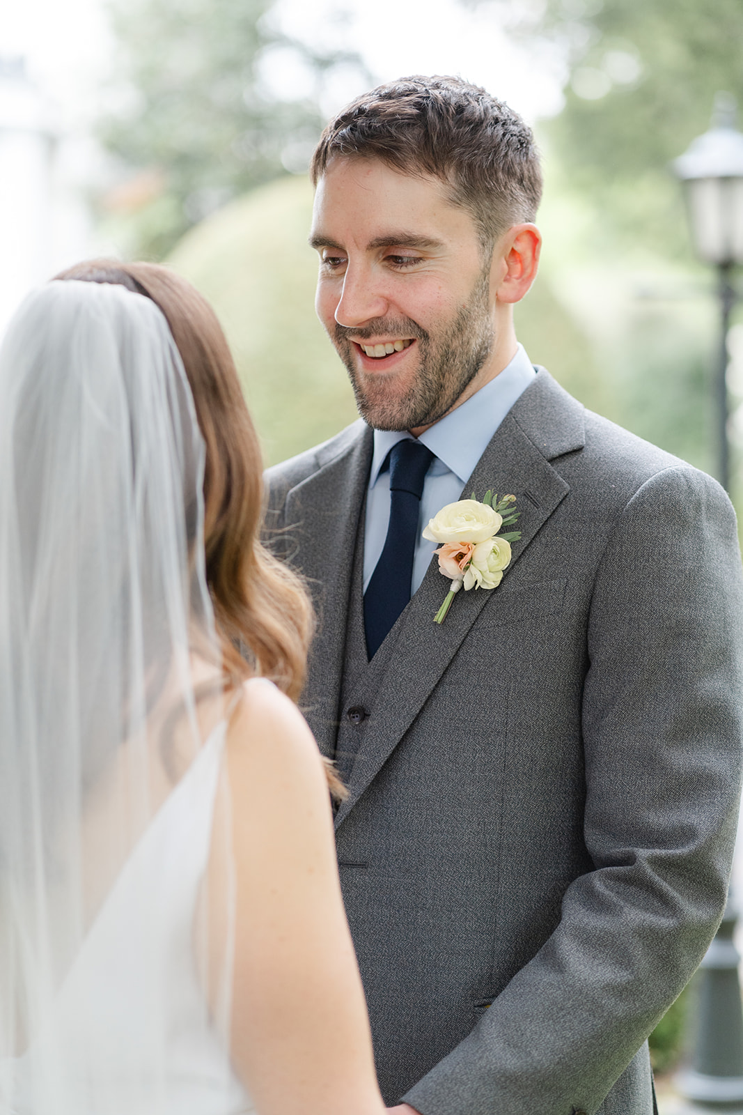 groom smiles at bride