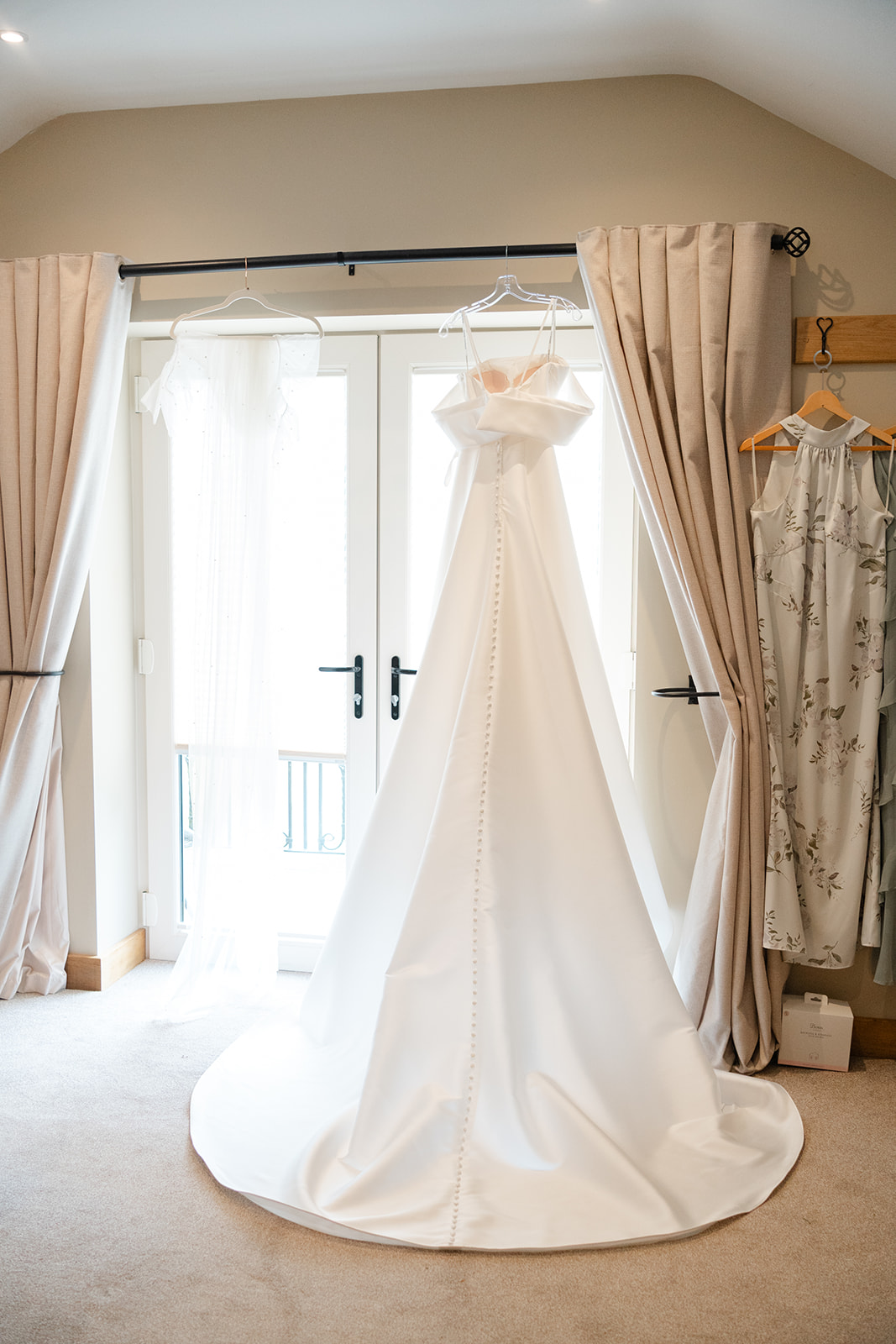 brides dress hanging in dressing room at hobbit hill