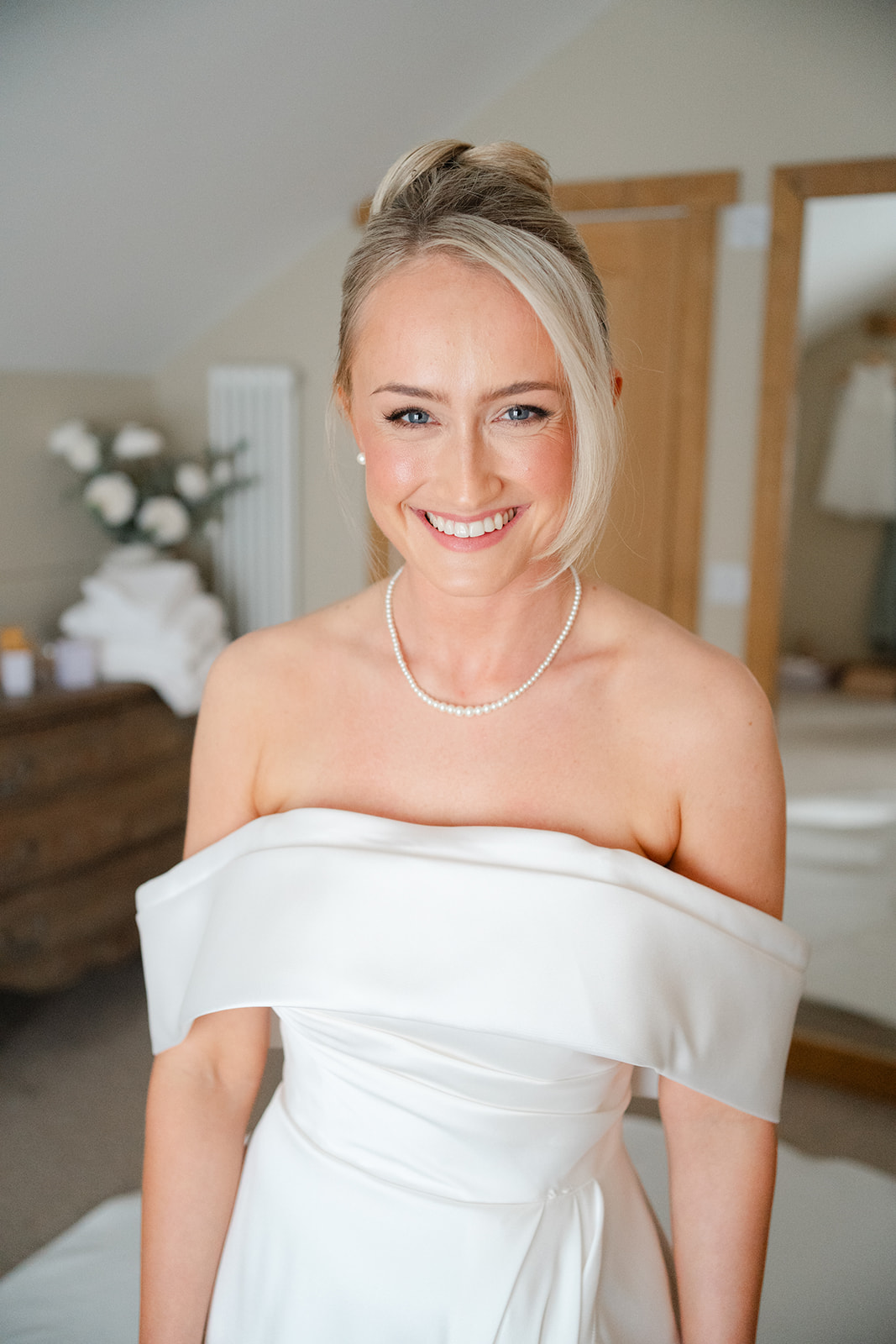 happy bride with blonde hair in the dressing room at hobbit hill