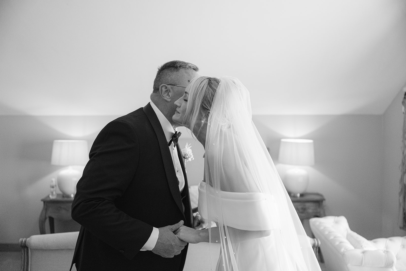 father of the bride kissing his daughter on the cheek