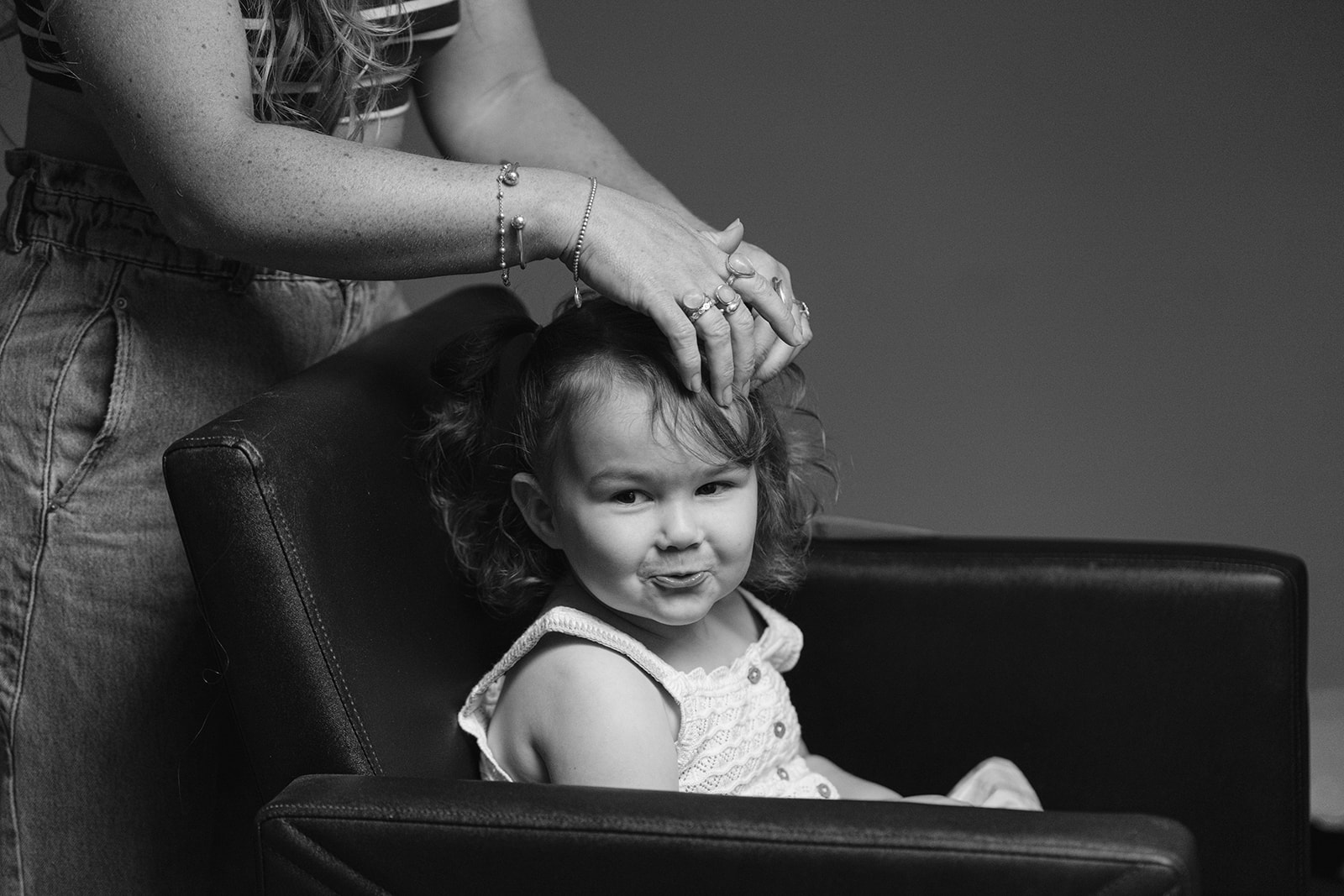cheeky flower girl having her hair done