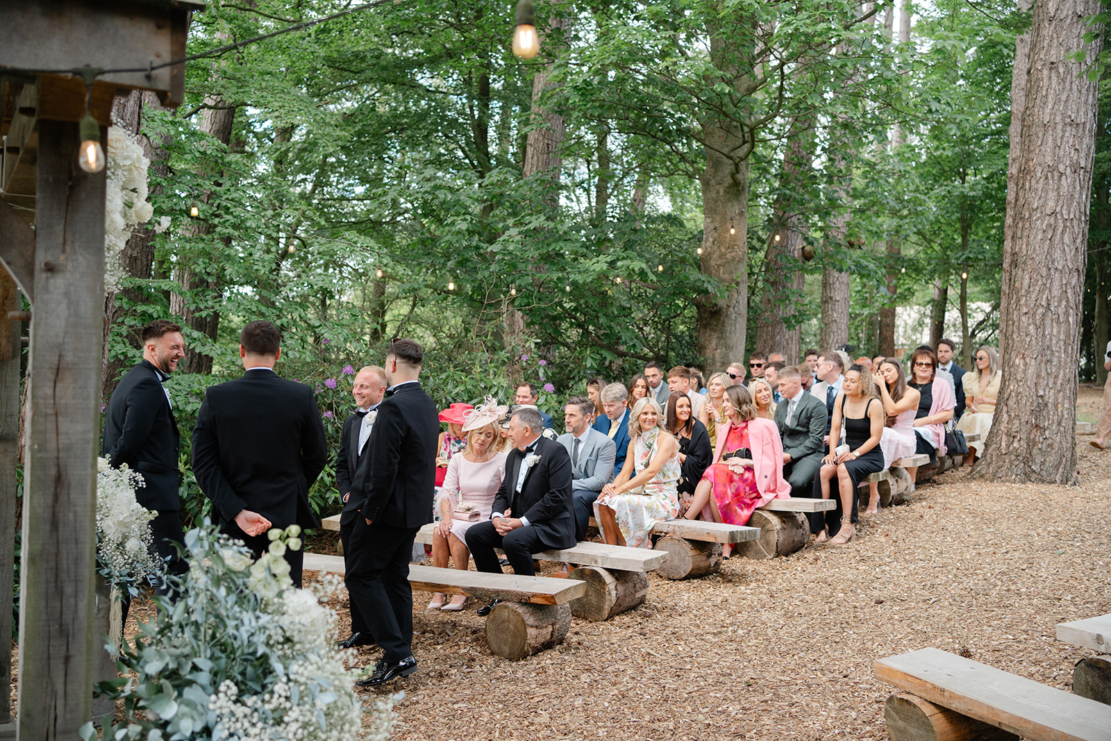 guests taking their seats in the woods for the ceremony at hobbit hill wedding venue