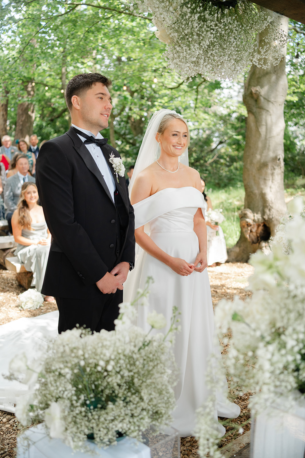beide and groom stand together during their outdoor ceremony in the woods at hobbit hill