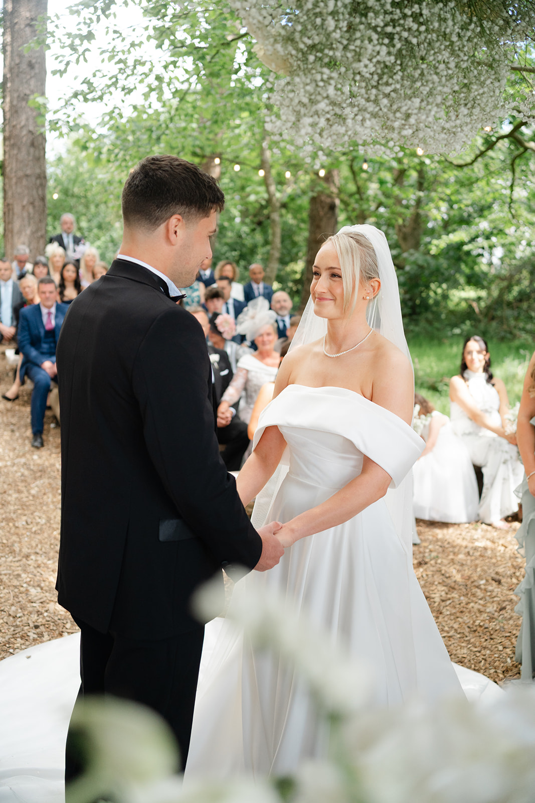 bride and groom saying their vows during outdoor ceremony in the woods at hobbit hill wedding venue