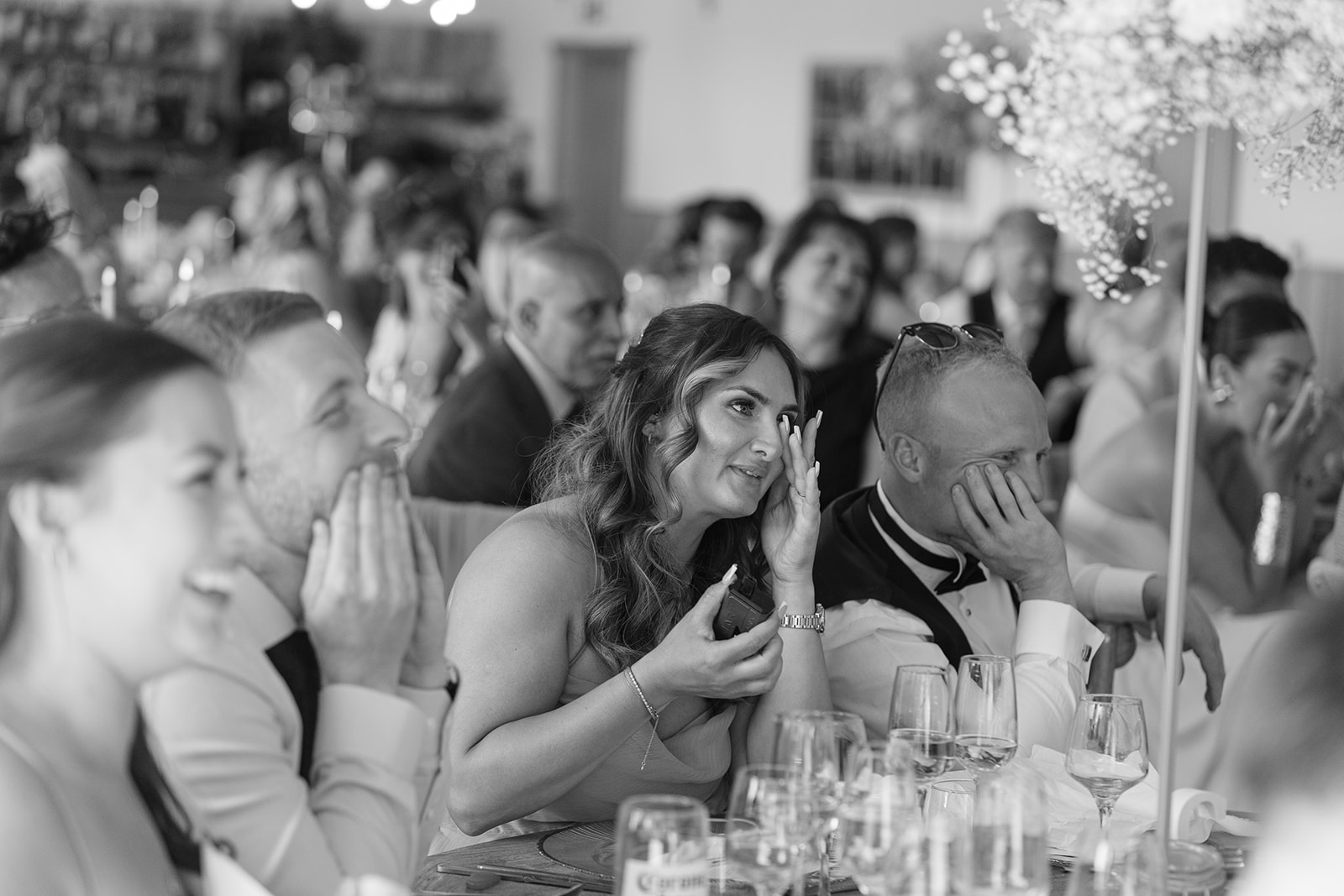 emotional guest wipes away tear during speeches