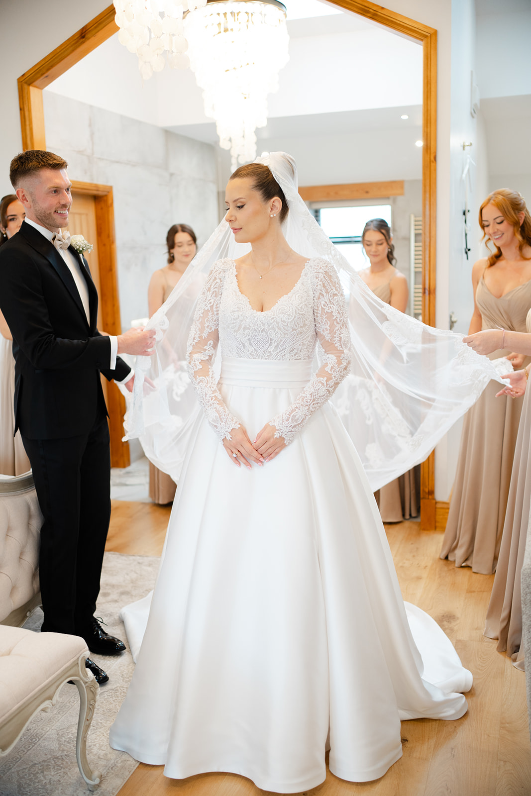 new bridal suite at beeston manor. Bride has her veil held by bridesmaids